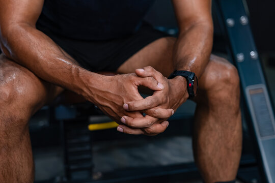Close Up of Focused Recovery Moment During Gym Training with Hands Clasped. Focused Athlete Resting with Hands Together During a Workout Break.