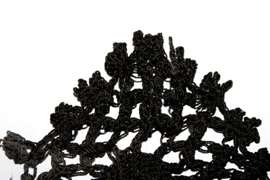 Close up of vintage black gothic lace fabric white on black background embroidery