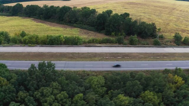 Long two-lane concrete road with traffic in rural area