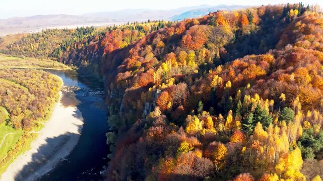 Shallow mountain river at foothill with terracotta forests