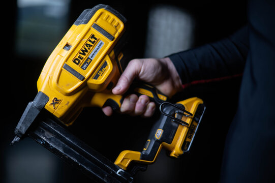Dewalt  nailer copy space image, used tool isolated on dark background