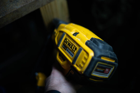 Dewalt  nailer copy space image, used tool isolated on dark background