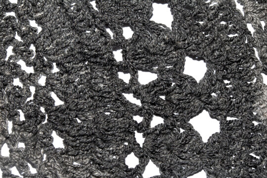 Close up of vintage black gothic lace fabric white on black background embroidery