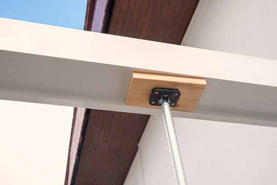 Mounting support rod for constructing a patio roof.