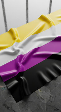 Fabric with yellow, white, purple, and black stripes laid on marble surface, a flag that represents an important social concept