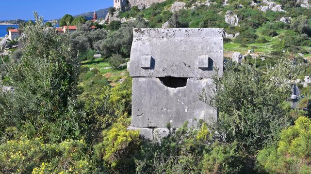 Ancient Lycian tomb with Simena Castle and Mediterranean Sea