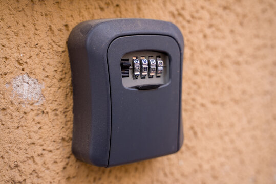 Wall mounted key lock box with combination code on exterior wall