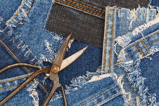 Crafting denim with scissors and fabric pieces in a workshop setting during the day