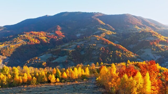High mountains with terracota trees at bright sunrise