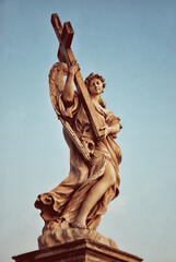 Fototapeta premium Angel with a cross on the Ponte Sant'Angelo. Rome, Italy