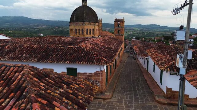 Close-up aerial view of the historic cathedral dome and rooftops in Barichara, Santander, Colombia