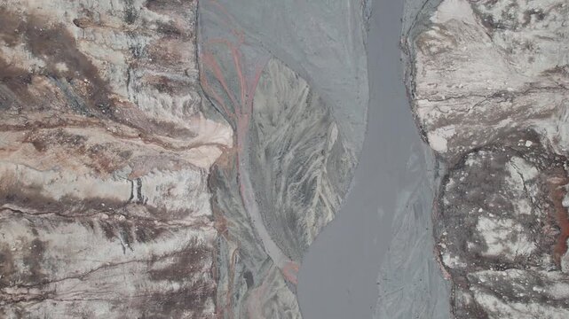 Abstract textures on the drained reservoir floor at Vidraru Dam with mineral patterns and sediment layers	
