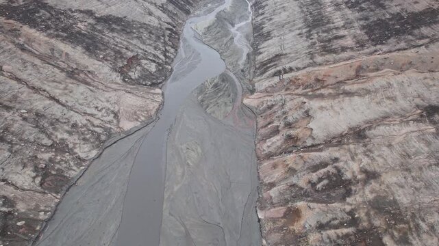Abstract textures on the drained reservoir floor at Vidraru Dam with mineral patterns and sediment layers	
