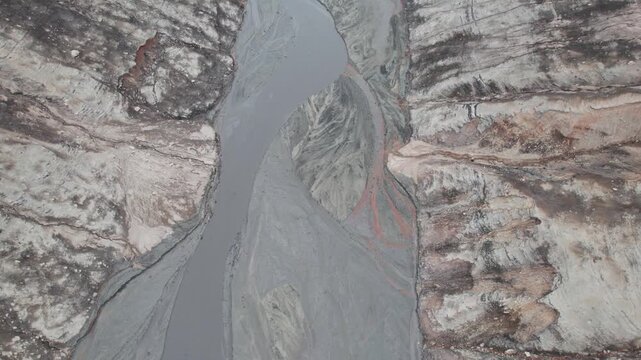 Abstract textures on the drained reservoir floor at Vidraru Dam with mineral patterns and sediment layers	
