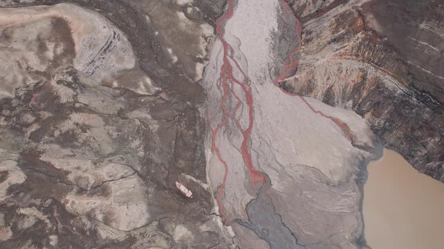 Abstract textures on the drained reservoir floor at Vidraru Dam with mineral patterns and sediment layers	