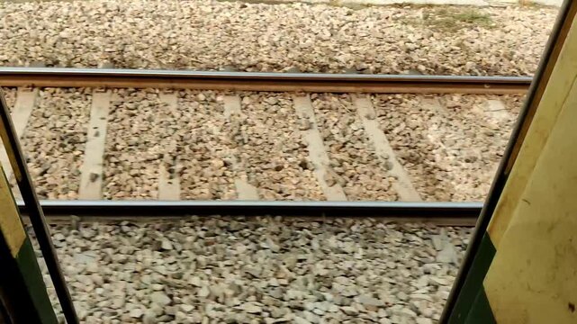 Changing railway track view captured from a moving train ride