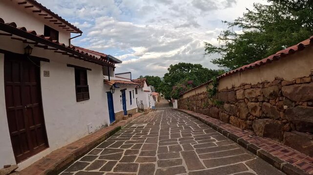 Panoramic view of a traditional cobblestone street in a colonial town with white houses and historic architecture