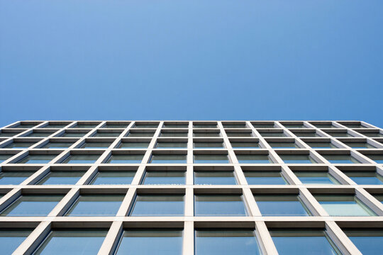 Modern building facade detail, grid pattern of windows, architectural geometry