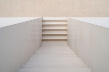 Fototapeta premium Minimalist white concrete staircase leading upwards outdoors