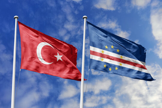 Turkiye and Cape Verde flags waving in a clear blue sky, symbolizing a powerful diplomacy a strategic partnership, and a shared vision of unity for a sustainable future.
