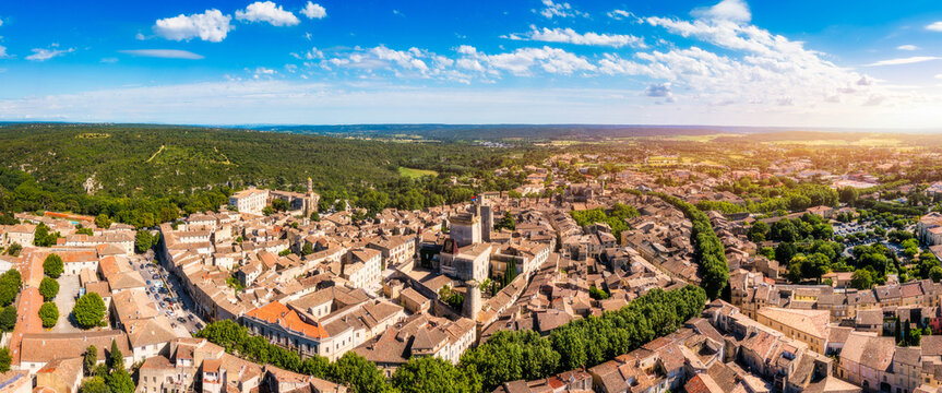 Overlooking Uzes in Gard, France, this scene captures the charming stone buildings and rooftops of the city. Scenic view of Uzes city in Gard, France showcasing historic architecture. Gard, France.
