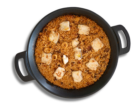 Seafood paella with monkfish and squid on white background