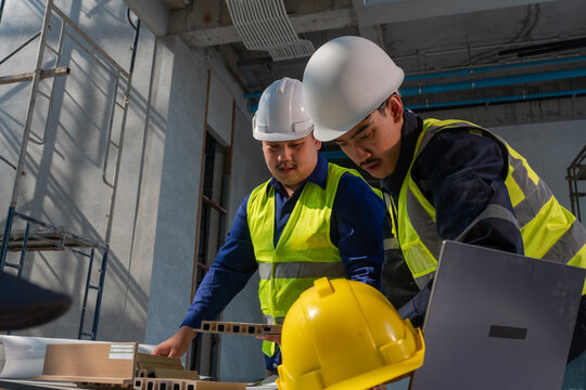Construction workers collaborate on project industrial site photography indoor environment close-up view teamwork in action