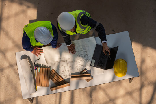 Project planning meeting construction site team collaboration indoor workspace overhead view engineering concepts