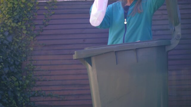 Reycling plastic carton of milk in the bin 