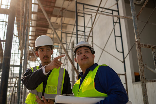 Construction project planning worksite team collaboration urban setting close-up view professional guidance