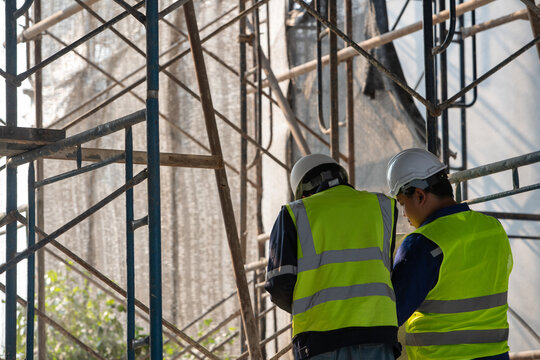 Construction workers collaborate on site urban construction zone image outdoor environment close-up viewpoint teamwork concept