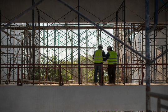 Construction collaboration between engineers urban site image capture industrial environment elevated viewpoint project planning
