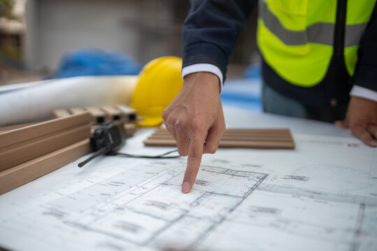 Construction planning action job site blueprint review professional environment close-up view project organization for success
