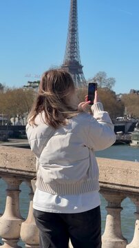 Travel enthusiast taking picture near river with scenic background