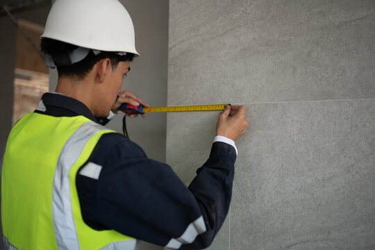 Measuring construction progress building site professional activity urban environment close-up view precision and planning