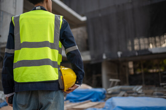 Construction worker in safety gear at building site detailed view of industrial environment focus on safety practices