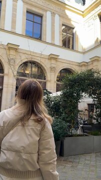 Traveler gazes at elegant classical windows and charming outdoor setting