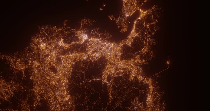 Kitakyushu (Japan) aerial view at night. Top view on modern city with glow effect. Camera is zooming out, rotating counterclockwise