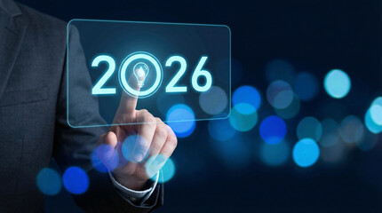 Fototapeta premium Businessman interacting with futuristic interface displaying 2026 with lightbulb on transparent screen