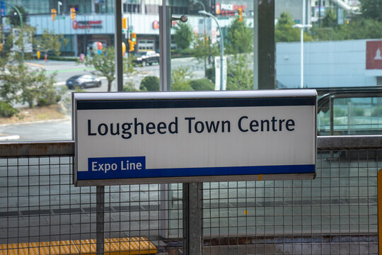Burnaby, BC, CANADA - Aug 10 2024 : Lougheed Town Centre sign at a SkyTrain station in British Columbia, showing Expo Line information and urban surroundings.