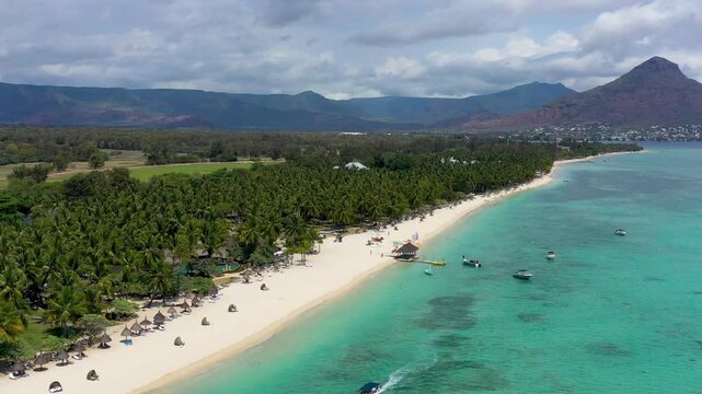 Mauritius, Black River, Flic-en-Flac, Aerial view of coastal beach in summer with Tourelle du Tamarin mountain in distant background. Mauritius island with gorgeous beach Flic en flac.