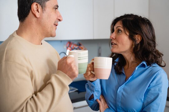 Casual Coffee Conversation at Home. Engaging coffee chat in a home kitchen environment for connection