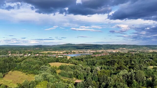 Scenic view of Tismana village in Gorj County Romania under a bright blue sky with fluffy clouds. A stunning landscape captures the beauty of Tismana village in Gorj County. Tismana, Romania.