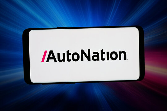 Stuttgart, Germany - 04-13-2026: In this photo illustration, the logo of US automotive retail company AutoNation Inc. is displayed on a smartphone in front of abstract background on computer screen.