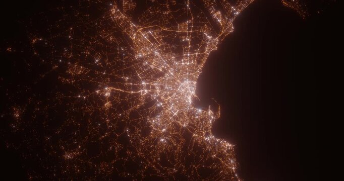 Palma (Spain) top view at night. Aerial view on modern city with lights. Camera is flying above the city, moving backward. Vertical video. The north is on the left side