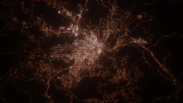 Missoula (Montana, USA) aerial view at night. Top view on modern city with street lights. Camera is zooming out, rotating clockwise
