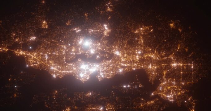 Seattle (Washington, USA) top view at night. Aerial view on modern city from space. Camera is flying above the city, moving forward. Vertical video. The north is on the left side