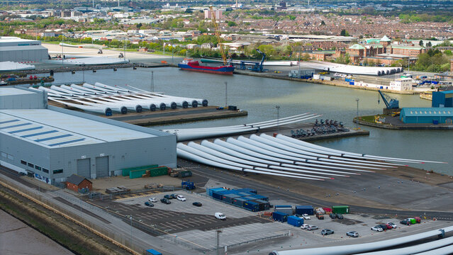 Aerial view of the Siemens Gamesa Renewable Energy facility showing rows of large wind turbine blades at the port with industrial buildings and ships Kingston upon Hull, England, United Kingdom.