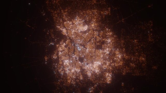 Ouagadougou (Burkina Faso) top view at night. Aerial view on modern city with lights. Camera is flying above the city, moving backward. Vertical video. The north is on the left side