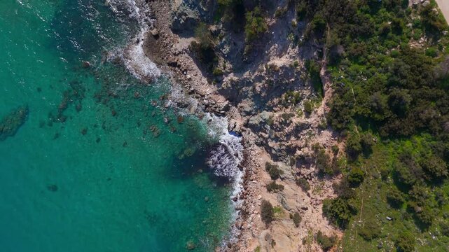 Vertical Aerial Over Steep Rugged Cliffs and Clear Mediterranean Waters in Akamas Cyprus
